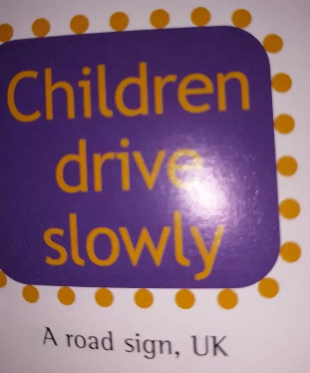 Road sign, UK: "Children drive slowly"