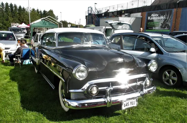 A black 1950s saloon with a chrome grille